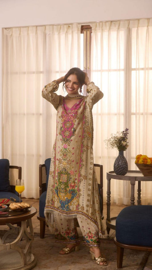 Woman in a traditional outfit standing in a room with curtains and furniture.